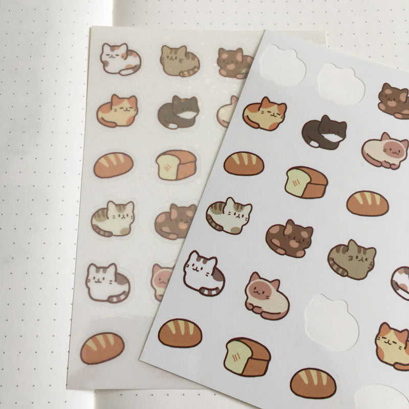 clear holo sticker sheet next to the matte paper sticker sheet